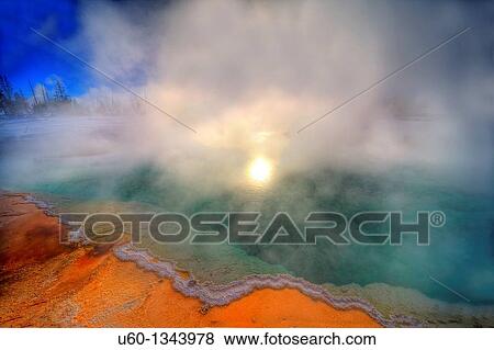 Stock Photo - The sun shines through the steam on Black Pool, a hot spring at Yellowstone National Park, Wyoming. Fotosearch