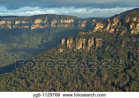Stock Photo - The Three Sisters, rock formation at sunrise, Blue Mountains National Park, Australia. Fotosearch