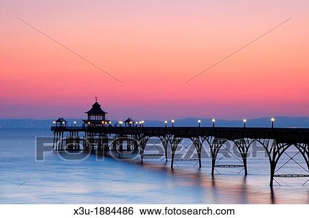 The Victorian pier in the Bristol Channel at the seaside town of Clevedon at dusk North Somerset, England, United Kingdom View Large Photo Image Stock Photograph - The Victorian pier in the Bristol Channel at the seaside town of Clevedon at dusk North Somerset, England, United Kingdom. Fotosearch