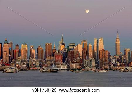 The waxing gibbous moon sits high in the magenta colored twilight sky over the New York City skyline the day before the full moon, as the orange glow of the sunset in the west reflects off the windows and facades of the Manhattan skyscrapers View Large Photo Image Stock Image - The waxing gibbous moon sits high in the magenta colored twilight sky over the New York City skyline the day before the full moon, as the orange glow of the sunset in the west reflects off the windows and facades of the Manhattan skyscrapers. Fotosearch