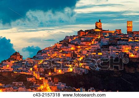 The White Town of Arcos de la Frontera on a limestone rock at dawn. Arcos de la Frontera, CBdiz province, Andalusia, Spain. View Large Photo Image Stock Photo - The White Town of Arcos de la Frontera on a limestone rock at dawn. Arcos de la Frontera, CBdiz province, Andalusia, Spain.. Fotosearch