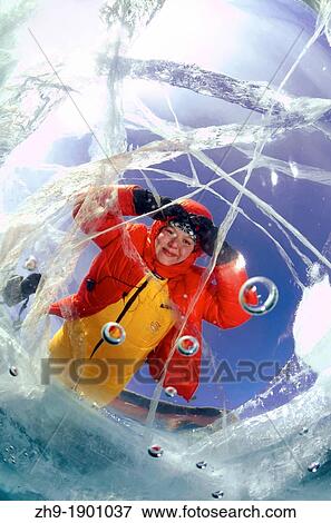 The woman looks through ice lake Baikal, Siberia, Russia, island Olkhon View Large Photo Image Stock Photo - The woman looks through ice lake Baikal, Siberia, Russia, island Olkhon. Fotosearch
