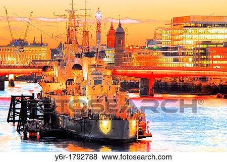 The World War Two battle-cruiser HMS Belfast moored on the River Thames near London Bridge, London, England, as a tourist attraction and pictured in a Winter twilight View Large Photo Image Stock Photo - The World War Two battle-cruiser HMS Belfast moored on the River Thames near London Bridge, London, England, as a tourist attraction and pictured in a Winter twilight. Fotosearch