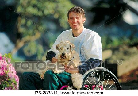 Therapy dog with quadriplegic man View Large Photo Image Stock Image - Therapy dog with quadriplegic man. Fotosearch