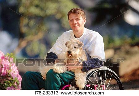Therapy dog with quadriplegic man View Large Photo Image Stock Image - Therapy dog with quadriplegic man. Fotosearch