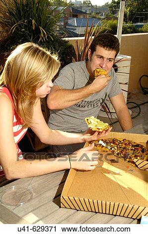 Stock Image - There's no way to eat a pizza with dignity.. Fotosearch