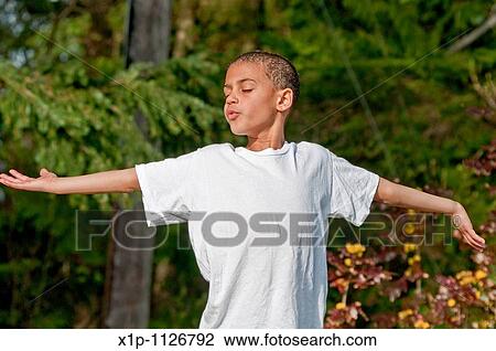 This candid image shows an cute 8 year old multi ethnic boy with his arms outstretched and eyes closed in a childhood moment that exudes freedom concepts He's outside with the background intentionally blurred to emphasize subject View Large Photo Image Stock Image - This candid image shows an cute 8 year old multi ethnic boy with his arms outstretched and eyes closed in a childhood moment that exudes freedom concepts He's outside with the background intentionally blurred to emphasize subject. Fotosearch
