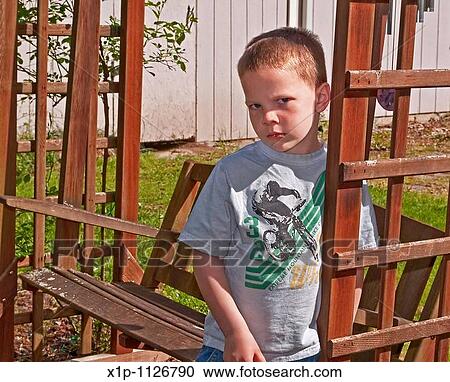 This Caucasian 5 year old boy is sad and upset as he's leaning against a cedar swing outside His eyes and facial expression and body language convey deep emotions View Large Photo Image Stock Image - This Caucasian 5 year old boy is sad and upset as he's leaning against a cedar swing outside His eyes and facial expression and body language convey deep emotions. Fotosearch