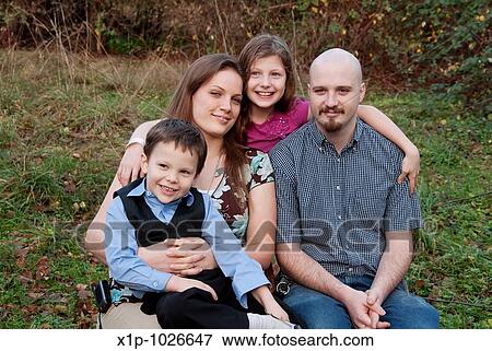 This cute young family is smiling and happy together while outdoors in a portrait setting Background intentionally blurred for artistic effect View Large Photo Image Stock Photo - This cute young family is smiling and happy together while outdoors in a portrait setting Background intentionally blurred for artistic effect. Fotosearch