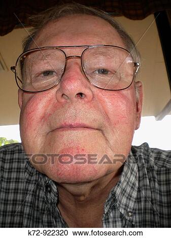 This elderly man has a slight smile on his face View Large Photo Image Stock Image - This elderly man has a slight smile on his face. Fotosearch