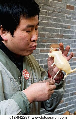 Stock Photo - this man use suger making cow.. Fotosearch
