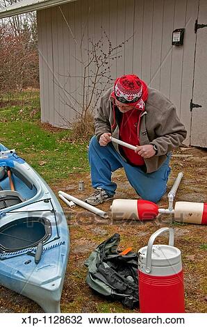 This middle aged man is preparing for kayak season in early spring by building an outrigger for his kayak out of PVC pipe, glue and crab buoys This is a project done at home for the handyman View Large Photo Image Stock Image - This middle aged man is preparing for kayak season in early spring by building an outrigger for his kayak out of PVC pipe, glue and crab buoys This is a project done at home for the handyman. Fotosearch