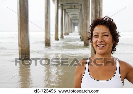 This portrait is of a 56 year old woman from San Diego, CA. She is of 100% Micronesian descent, specifically the island of Guam. The pier in the background is Scripp's Pier in La Jolla, California, USA View Large Photo Image Stock Photography - This portrait is of a 56 year old woman from San Diego, CA. She is of 100% Micronesian descent, specifically the island of Guam. The pier in the background is Scripp's Pier in La Jolla, California, USA. Fotosearch