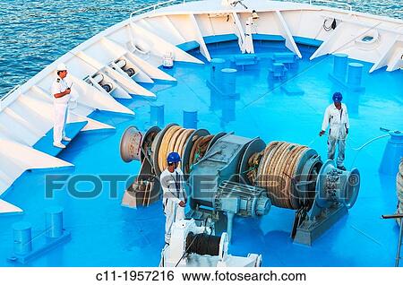 Stock Photograph - Thomson Destiny; men; working; foredeck; ship; nautical.. Fotosearch