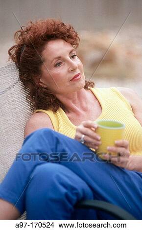 Thoughtful woman in chair View Large Photo Image Picture - Thoughtful woman in chair. Fotosearch
