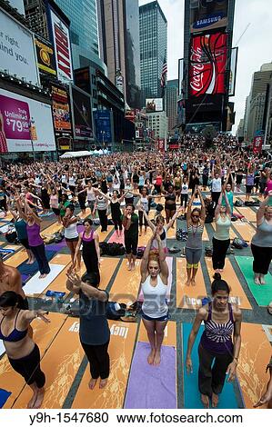 Thousands of yoga practitioners in Times Square in New York participate in a group Bikram Yoga class observing the Summer Solstice View Large Photo Image Stock Image - Thousands of yoga practitioners in Times Square in New York participate in a group Bikram Yoga class observing the Summer Solstice. Fotosearch