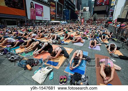 Thousands of yoga practitioners in Times Square in New York participate in a group Bikram Yoga class observing the Summer Solstice View Large Photo Image Stock Image - Thousands of yoga practitioners in Times Square in New York participate in a group Bikram Yoga class observing the Summer Solstice. Fotosearch