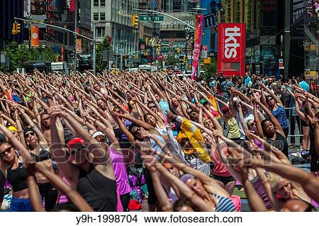 Thousands of yoga practitioners pack Times Square in New York to participate in a mid-day Bikram Yoga class on the first day of summer. View Large Photo Image Picture - Thousands of yoga practitioners pack Times Square in New York to participate in a mid-day Bikram Yoga class on the first day of summer.. Fotosearch