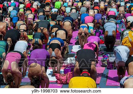 Thousands of yoga practitioners pack Times Square in New York to participate in a mid-day Bikram Yoga class on the first day of summer. View Large Photo Image Stock Image - Thousands of yoga practitioners pack Times Square in New York to participate in a mid-day Bikram Yoga class on the first day of summer.. Fotosearch