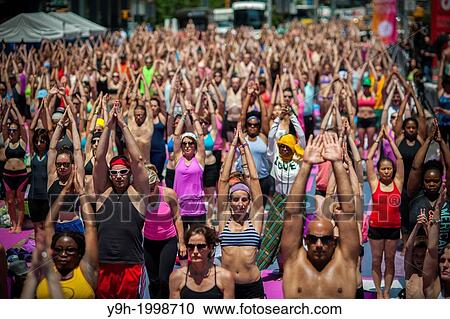 Thousands of yoga practitioners pack Times Square in New York to participate in a mid-day Bikram Yoga class on the first day of summer. View Large Photo Image Stock Image - Thousands of yoga practitioners pack Times Square in New York to participate in a mid-day Bikram Yoga class on the first day of summer.. Fotosearch