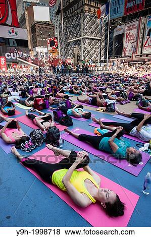 Thousands of yoga practitioners pack Times Square in New York to participate in a mid-day Bikram Yoga class on the first day of summer. View Large Photo Image Stock Photo - Thousands of yoga practitioners pack Times Square in New York to participate in a mid-day Bikram Yoga class on the first day of summer.. Fotosearch