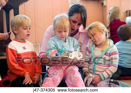 Three, 3 year old children reading with teacher at nursrey school View Large Photo Image Stock Photography - Three, 3 year old children reading with teacher at nursrey school. Fotosearch