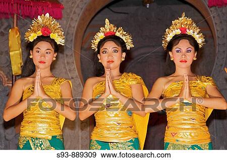 Stock Photo - Three Balinese dancers in traditional costumes lined up at the end of a dance performance in Ubud.. Fotosearch