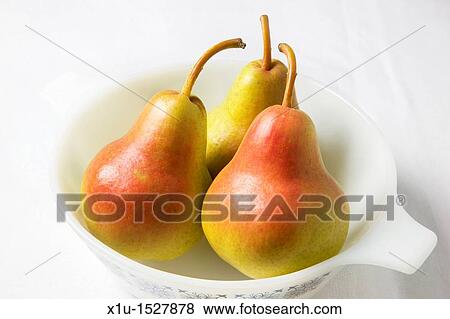 Three blush pears in a white dish View Large Photo Image Stock Photo - Three blush pears in a white dish. Fotosearch