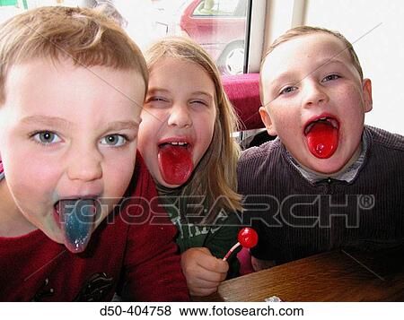 Three boys, aged 4 and 8, show off their colored tongues while sucking on flavoured lollipops View Large Photo Image Stock Photo - Three boys, aged 4 and 8, show off their colored tongues while sucking on flavoured lollipops. Fotosearch