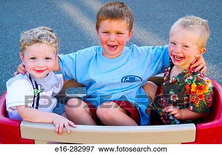 three boys in a wagon View Large Photo Image Stock Photo - three boys in a wagon. Fotosearch