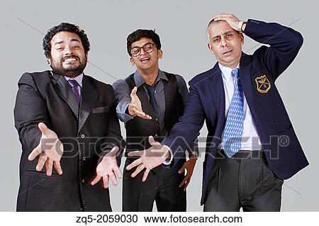 Stock Image - Three business men expressing sorrow over a disaster.. Fotosearch