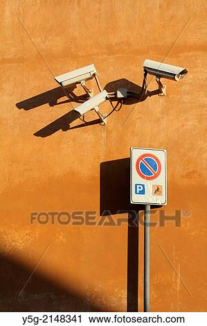 Stock Image - three cctv cameras on building wall in rome italy. Fotosearch