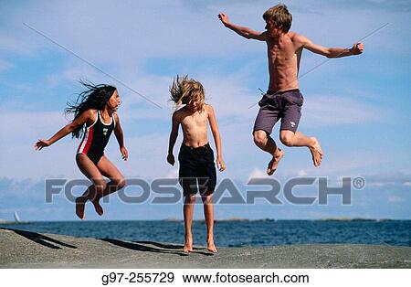 Three children jumping View Large Photo Image Stock Photo - Three children jumping. Fotosearch