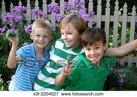Three cousins having fun in their backyard ages 6, 10 and 7. St Paul Minnesota MN USA. View Large Photo Image Stock Photo - Three cousins having fun in their backyard ages 6, 10 and 7. St Paul Minnesota MN USA.. Fotosearch