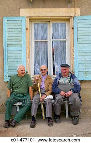 Stock Image - Three elderly men on a bench. Fontenoy-la-Jo? te. Lorraine. France.. Fotosearch