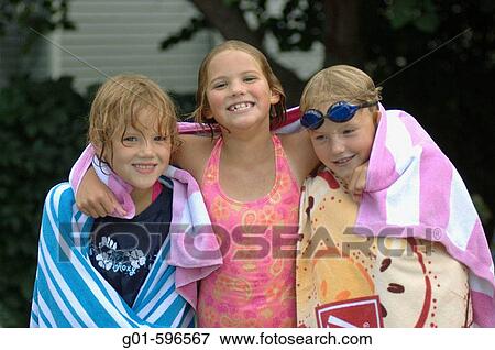 Three friends playing in a backyard pool View Large Photo Image Stock Photo - Three friends playing in a backyard pool. Fotosearch