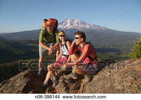 Three friends take a break while hiking near Mount Adams. Washington. USA View Large Photo Image Picture - Three friends take a break while hiking near Mount Adams. Washington. USA. Fotosearch
