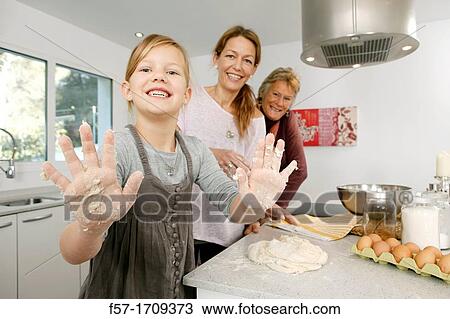 Three generations of women in the kitchen View Large Photo Image Stock Image - Three generations of women in the kitchen. Fotosearch