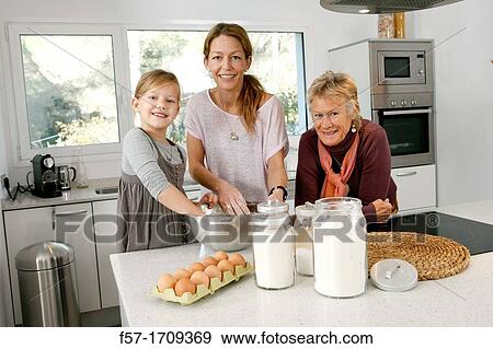 Three generations of women in the kitchen View Large Photo Image Stock Photo - Three generations of women in the kitchen. Fotosearch