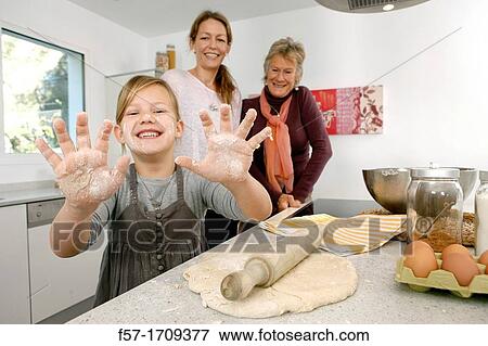 Three generations of women in the kitchen View Large Photo Image Stock Photo - Three generations of women in the kitchen. Fotosearch