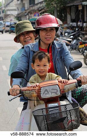 Three generations on a bike, Luang Prabang, Laos View Large Photo Image Picture - Three generations on a bike, Luang Prabang, Laos. Fotosearch