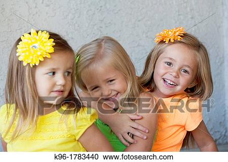 Stock Image - three girls being playful. Fotosearch