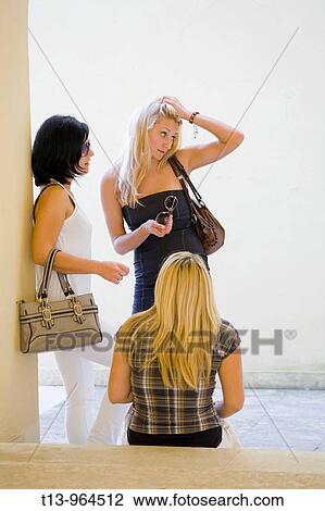Three girls chatting View Large Photo Image Stock Image - Three girls chatting. Fotosearch