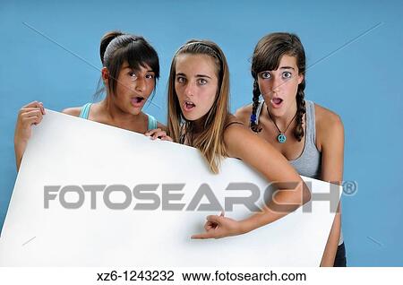 Three girls holding a blank sign, with blue backgroud View Large Photo Image Stock Image - Three girls holding a blank sign, with blue backgroud. Fotosearch