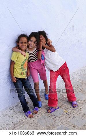 Three girls in the Medina, Chefchaouen, Morocco View Large Photo Image Stock Image - Three girls in the Medina, Chefchaouen, Morocco. Fotosearch