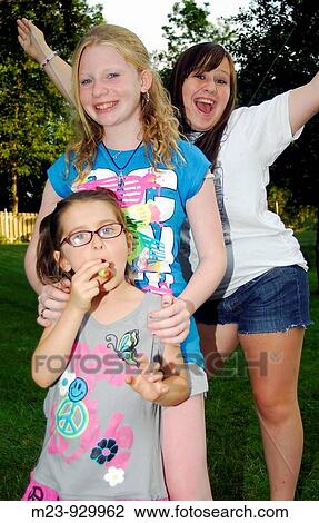 Three girls pose for the camera, Pennsylvania, USA View Large Photo Image Stock Image - Three girls pose for the camera, Pennsylvania, USA. Fotosearch
