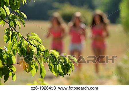 Three girls running at field View Large Photo Image Stock Image - Three girls running at field. Fotosearch