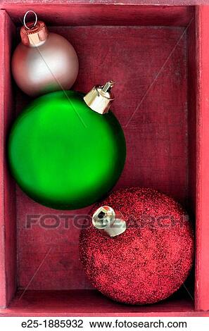 Three green, red and gold Christmas baubles close up in a red wooden box. View Large Photo Image Stock Image - Three green, red and gold Christmas baubles close up in a red wooden box.. Fotosearch
