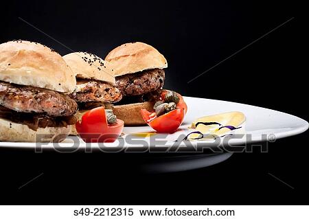 Three hamburgers on black background, close-up. View Large Photo Image Stock Photography - Three hamburgers on black background, close-up.. Fotosearch