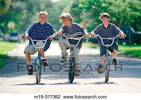 three kids riding their bikes View Large Photo Image Stock Image - three kids riding their bikes. Fotosearch